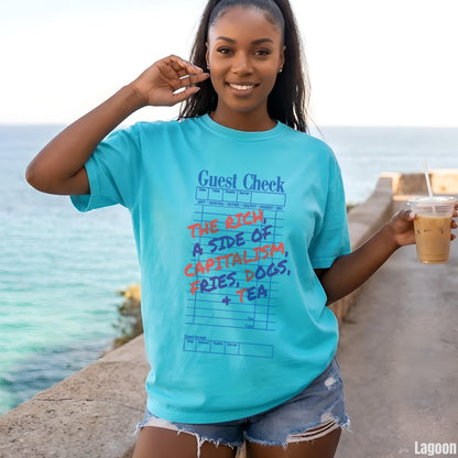 Woman wearing a turquoise t-shirt with &amp;quot;The Rich, a side of capitalism, fries, dogs, tea&amp;quot; printed on it.