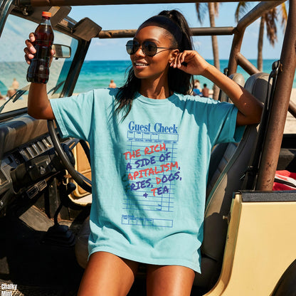 Woman in a mint t-shirt with &amp;quot;Guest Check&amp;quot; graphic and text about capitalism.