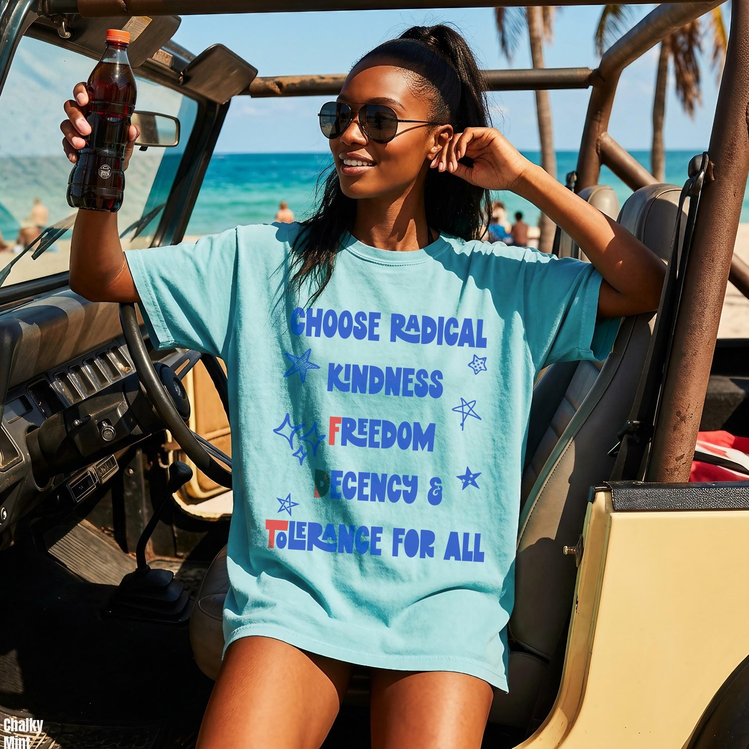 Teal t-shirt with &amp;quot;Choose Radical Kindness Freedom Tolerance For All&amp;quot; text, worn by a woman in a jeep.