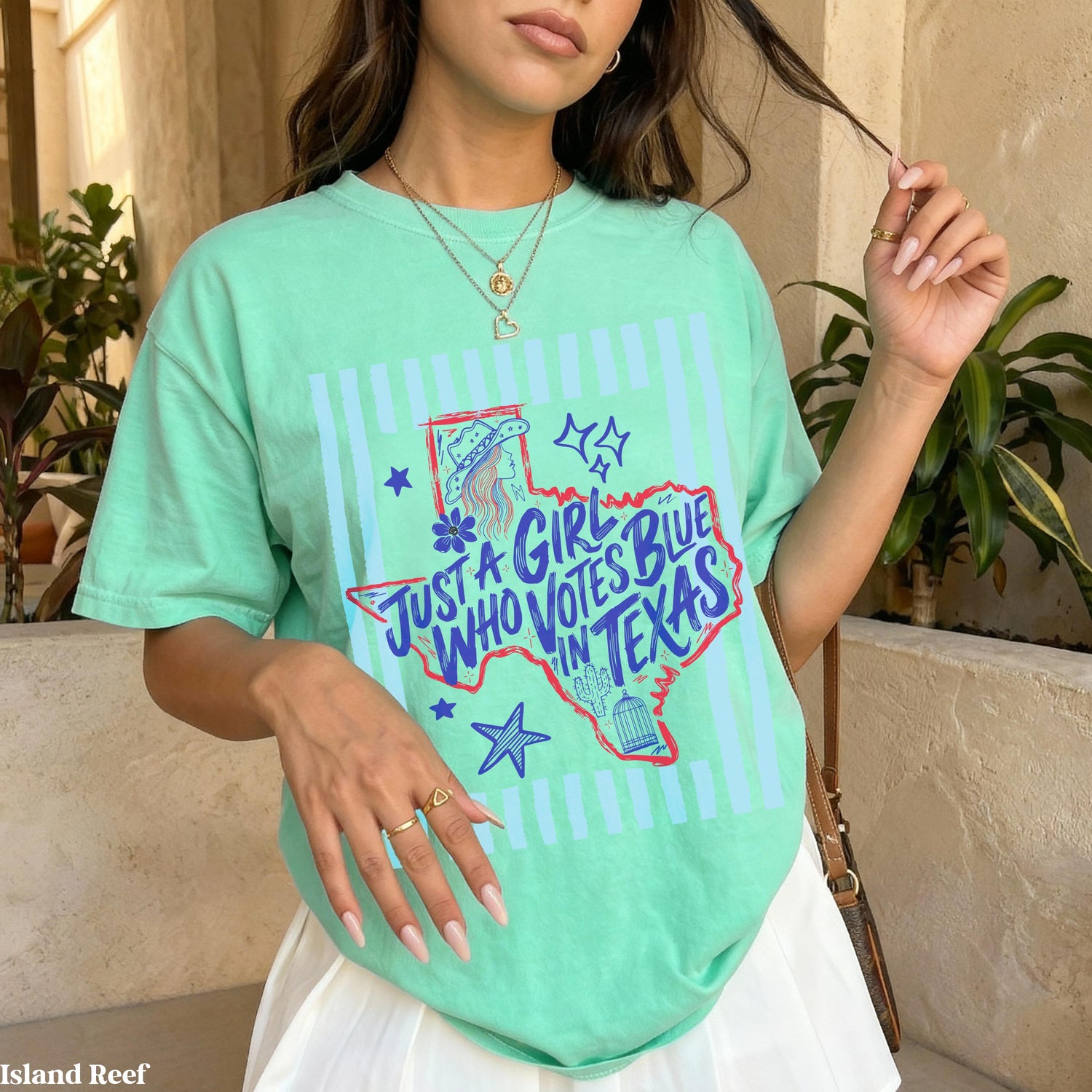 Mint green t-shirt with Texas graphic and text &amp;quot;Just a girl who votes blue in Texas&amp;quot;.