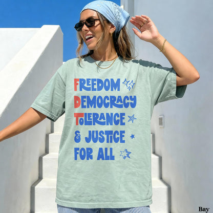 Light blue graphic tee with &amp;quot;FREEDOM DEMOCRACY TOLERANCE &amp; JUSTICE FOR ALL&amp;quot; text.