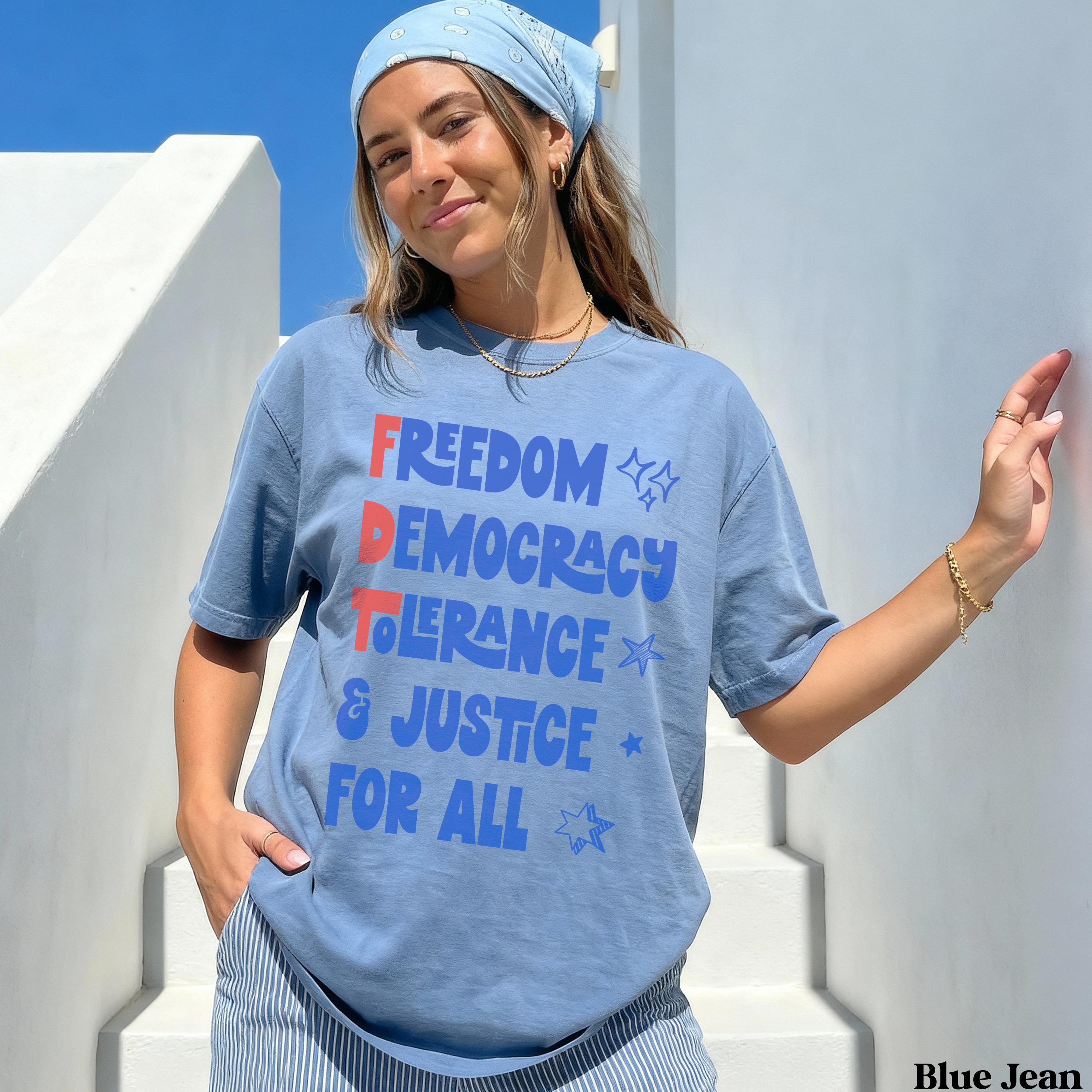 Blue t-shirt with red, white, and blue text: FREEDOM DEMOCRACY TOLERANCE &amp; JUSTICE FOR ALL.