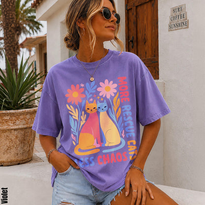 Purple t-shirt with cats, flowers, and &amp;quot;more love less chaos&amp;quot; text.