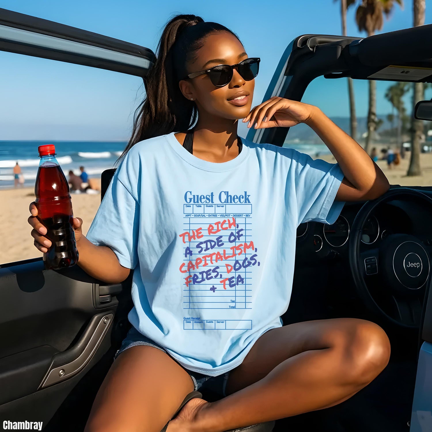 Light blue t-shirt with &amp;quot;Guest Check&amp;quot; and &amp;quot;The Rich, A Side Of Capitalism, Fries, Dogs, + Tea&amp;quot; text.
