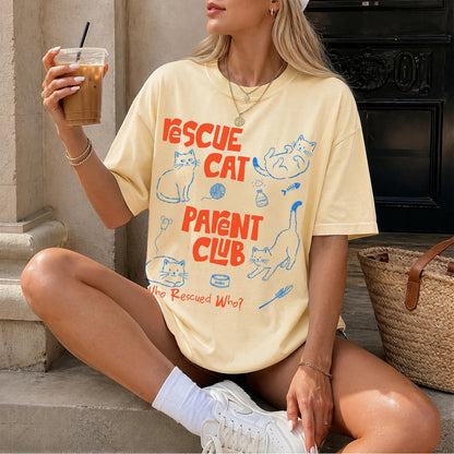Yellow t-shirt with &amp;quot;Rescue Cat Parent Club&amp;quot; text and cat illustrations.