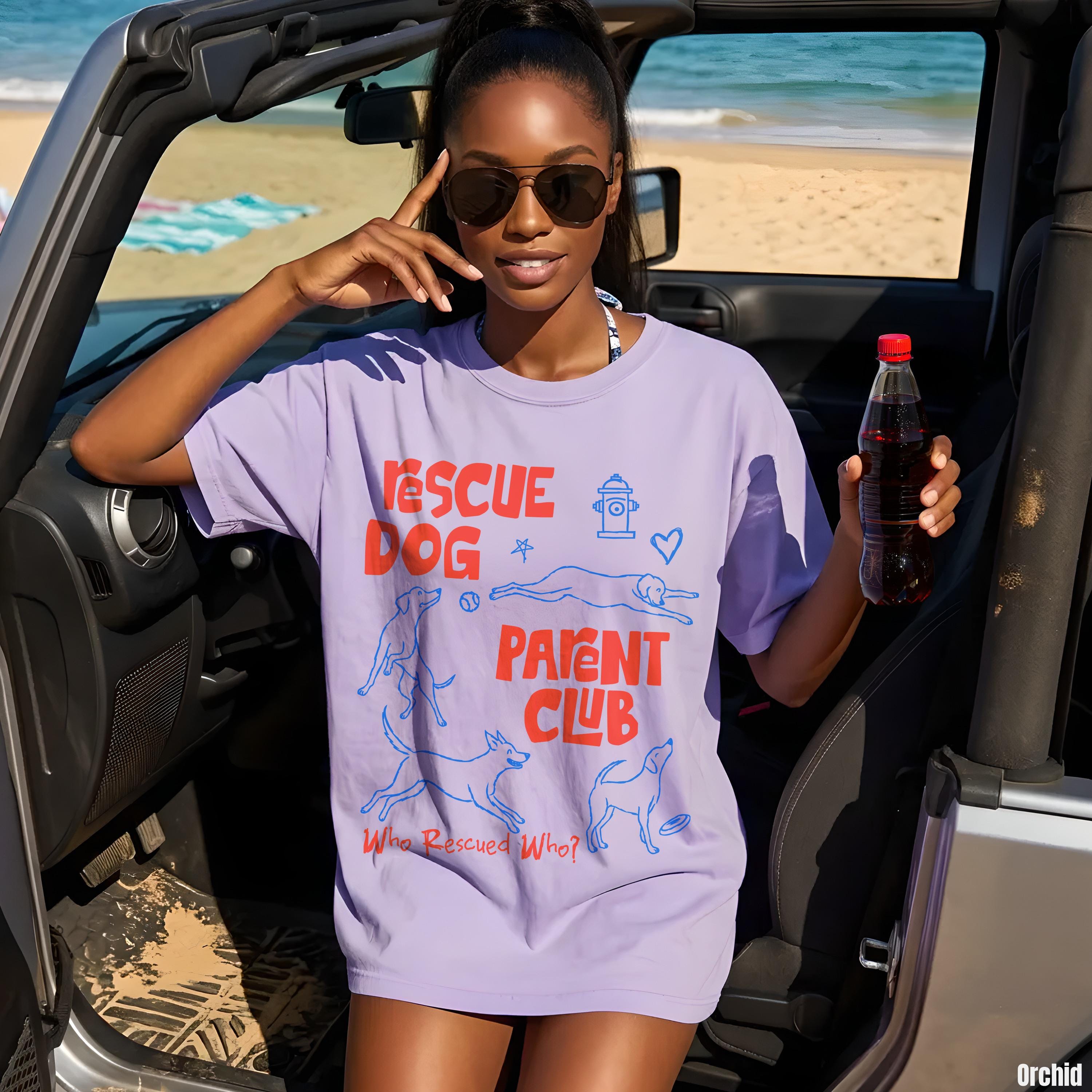 Woman wearing a lavender t-shirt with &amp;quot;Rescue Parent Club&amp;quot; text and dog graphics.