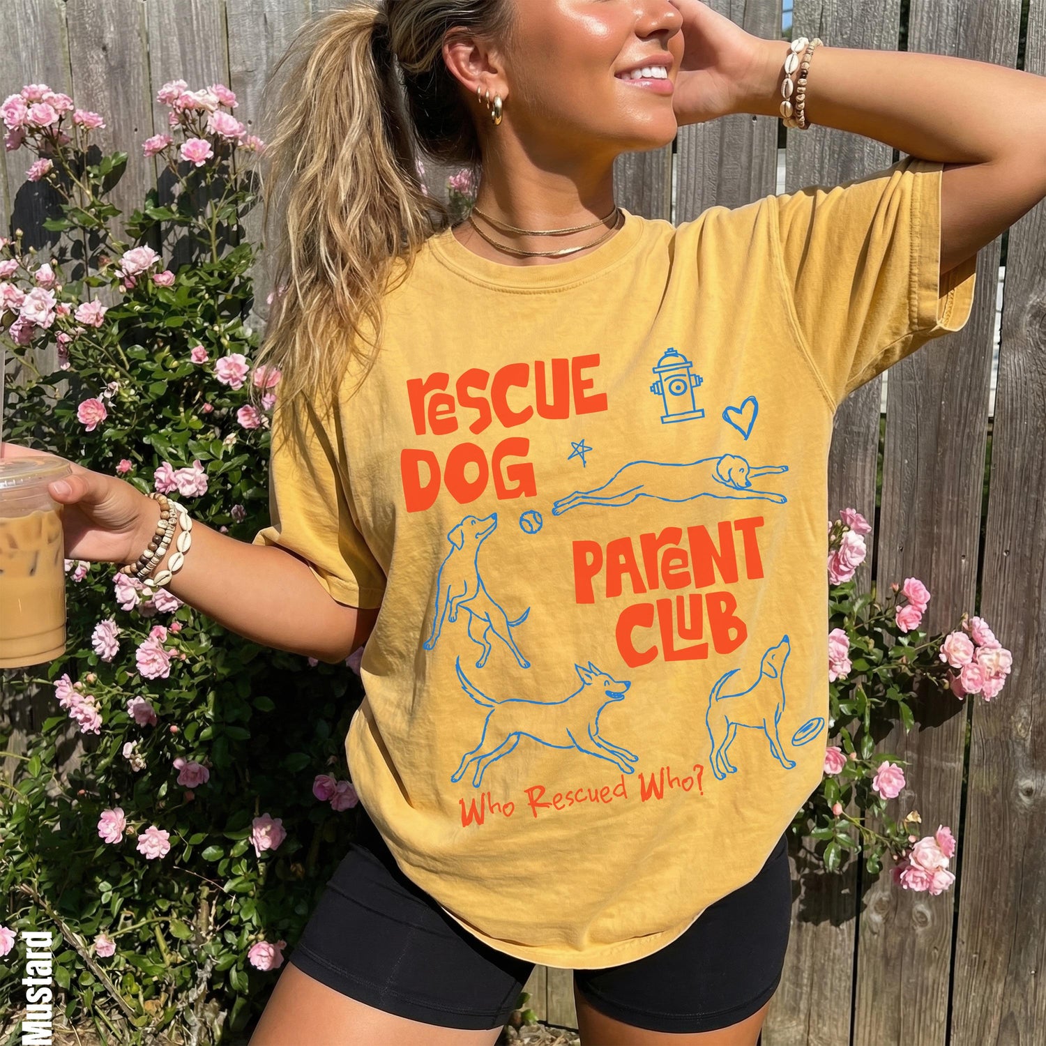 Yellow t-shirt with &amp;quot;Rescue Dog Parent Club&amp;quot; graphic and playful dog illustrations.