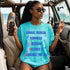 Woman in blue t-shirt with text "CHOOSE RADICAL FREEDOM KINDNESS DECENCY TOLERANCE FOR ALL"