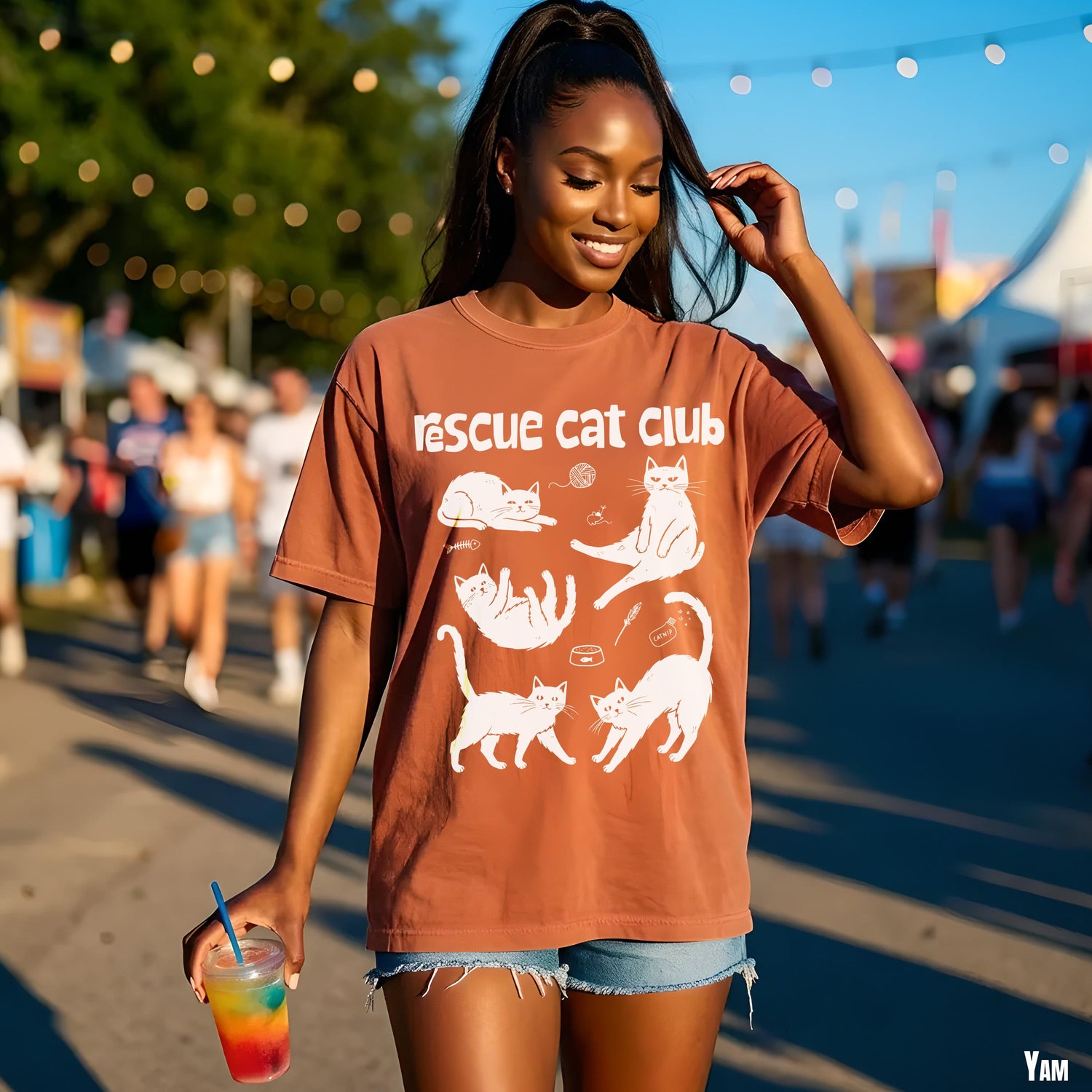 Woman in brown t-shirt with cats and &amp;quot;Rescue Cat Club&amp;quot; graphic.