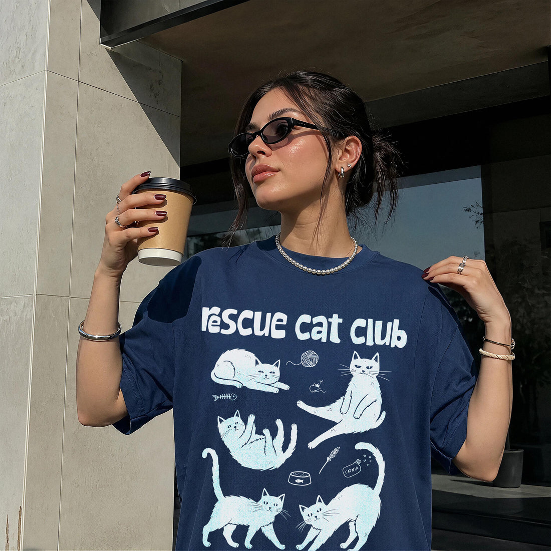 Dark blue t-shirt with white cat illustrations and &amp;quot;Rescue Cat Club&amp;quot; text.