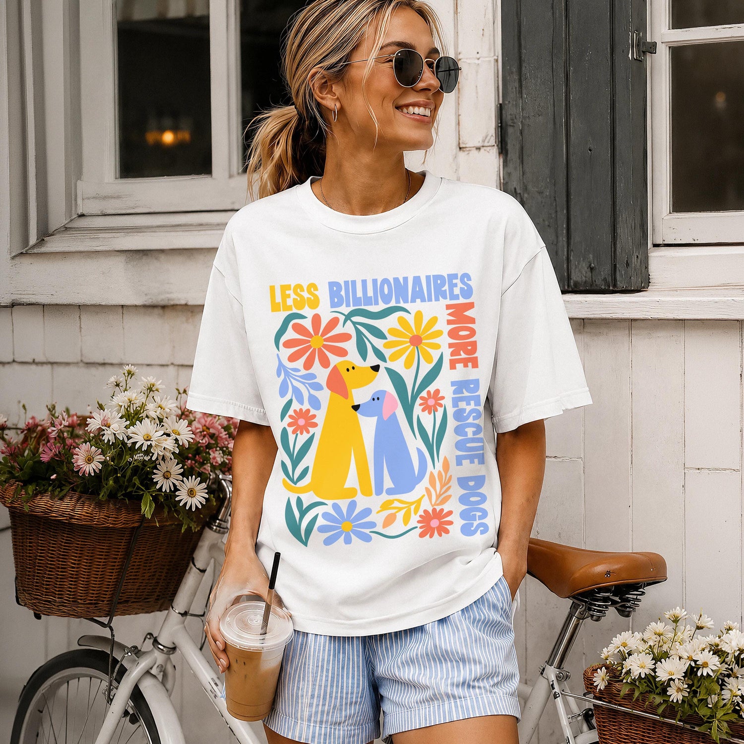Woman wearing white t-shirt with &amp;quot;Less Billionaires, More Rescue Dogs&amp;quot; and dog graphics.