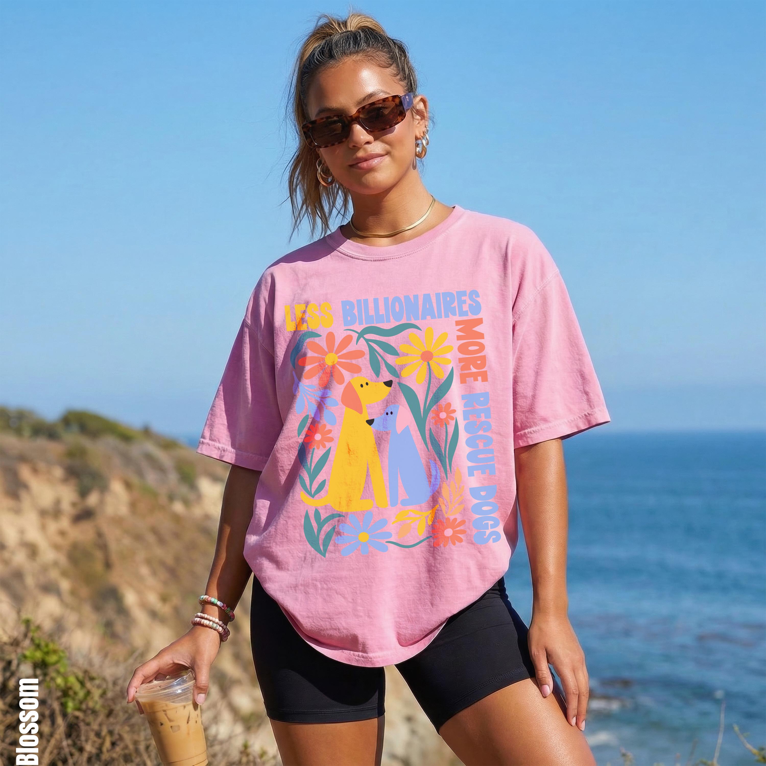 Pink t-shirt with floral and dog graphic and text &amp;quot;LESS BILLIONAIRES MORE RESCUE DOGS&amp;quot;.