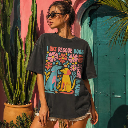Woman wearing black t-shirt with colorful floral and dog graphic.