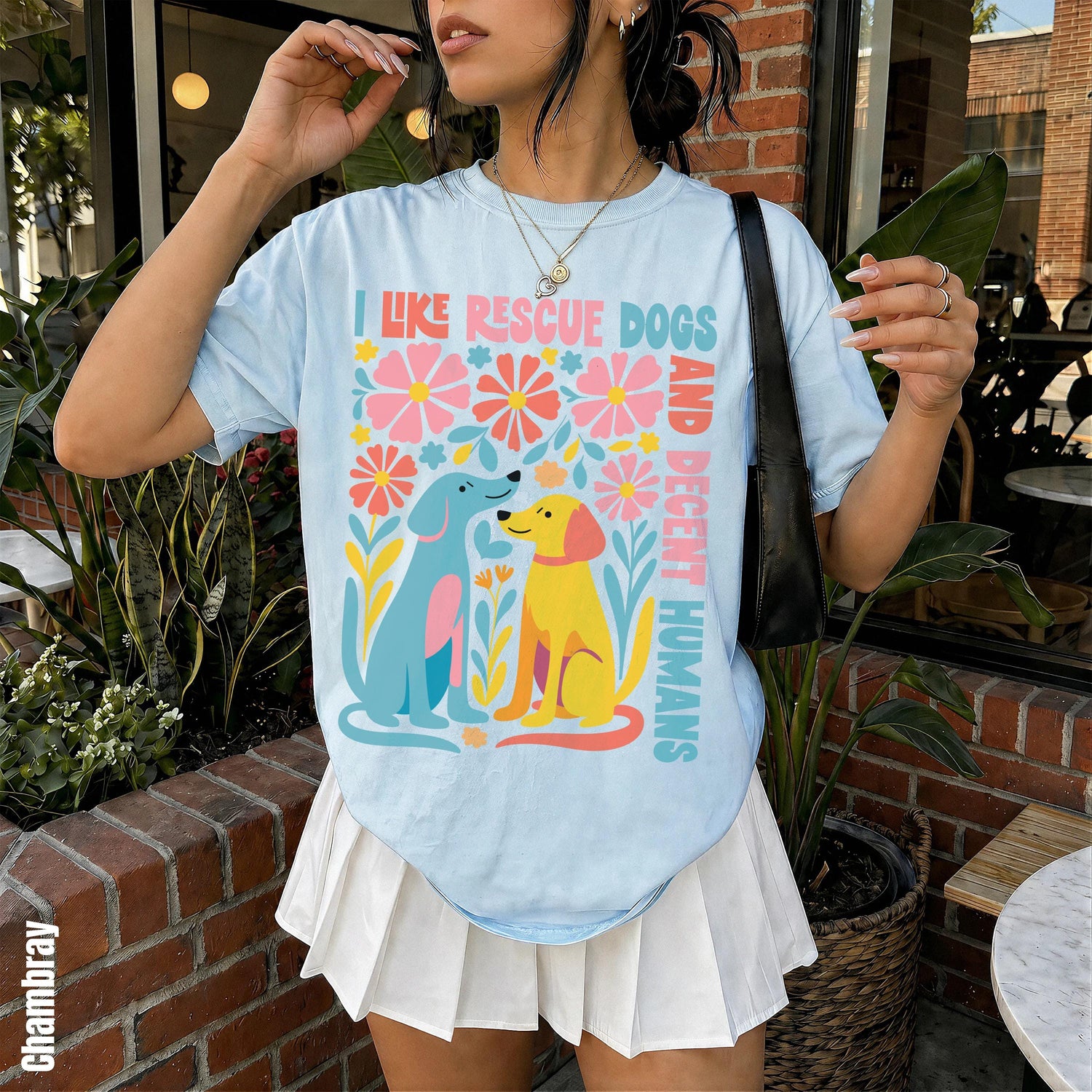 Light blue t-shirt with colorful floral design and dogs that reads &amp;quot;I Like Rescue Dogs and Their Humans&amp;quot;.