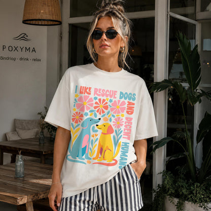 Woman wearing cream t-shirt with colorful &amp;quot;I like rescue dogs&amp;quot; graphic and striped shorts.