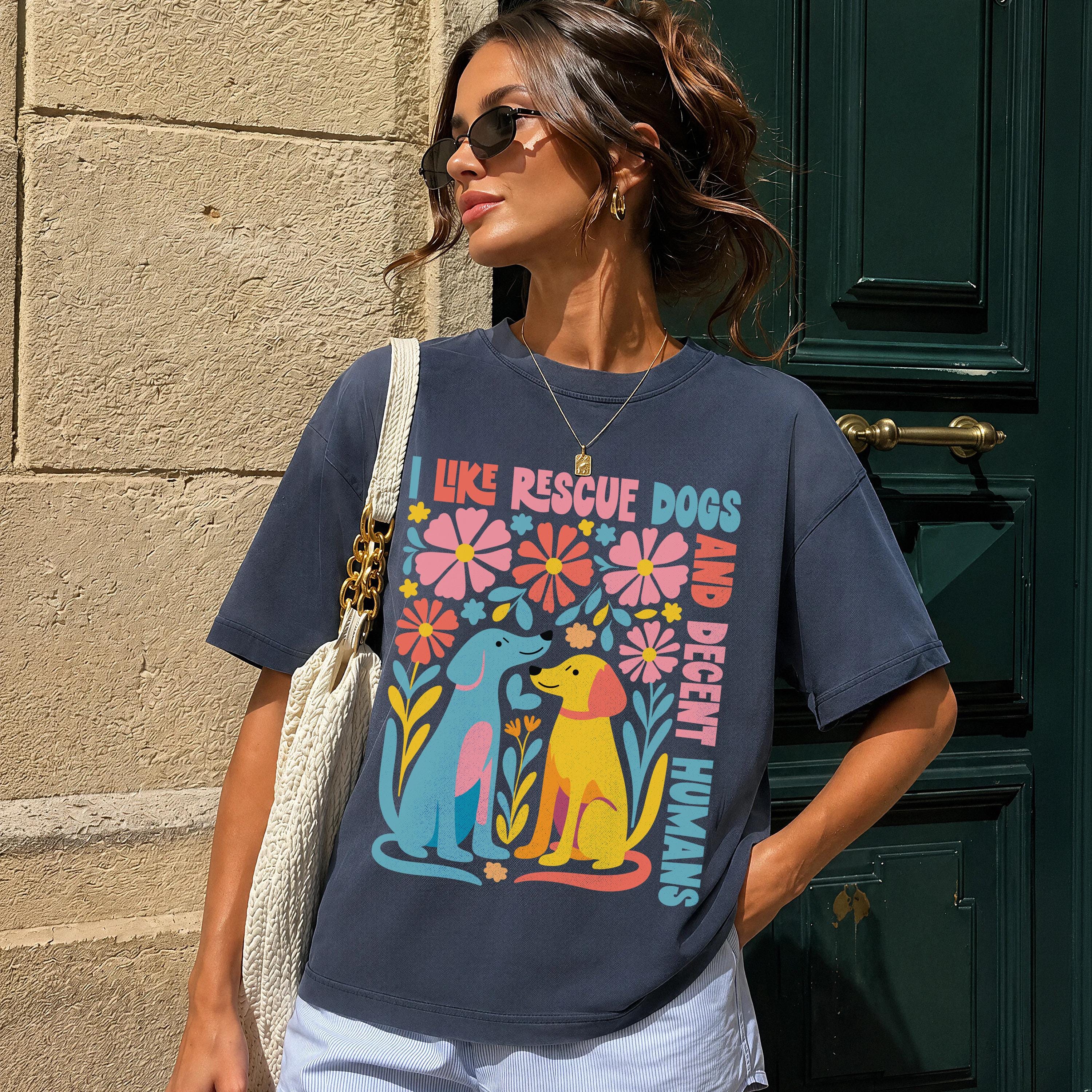Dark t-shirt with colorful graphic of two dogs and flowers, saying &amp;quot;I like rescue dogs and decent humans&amp;quot;.