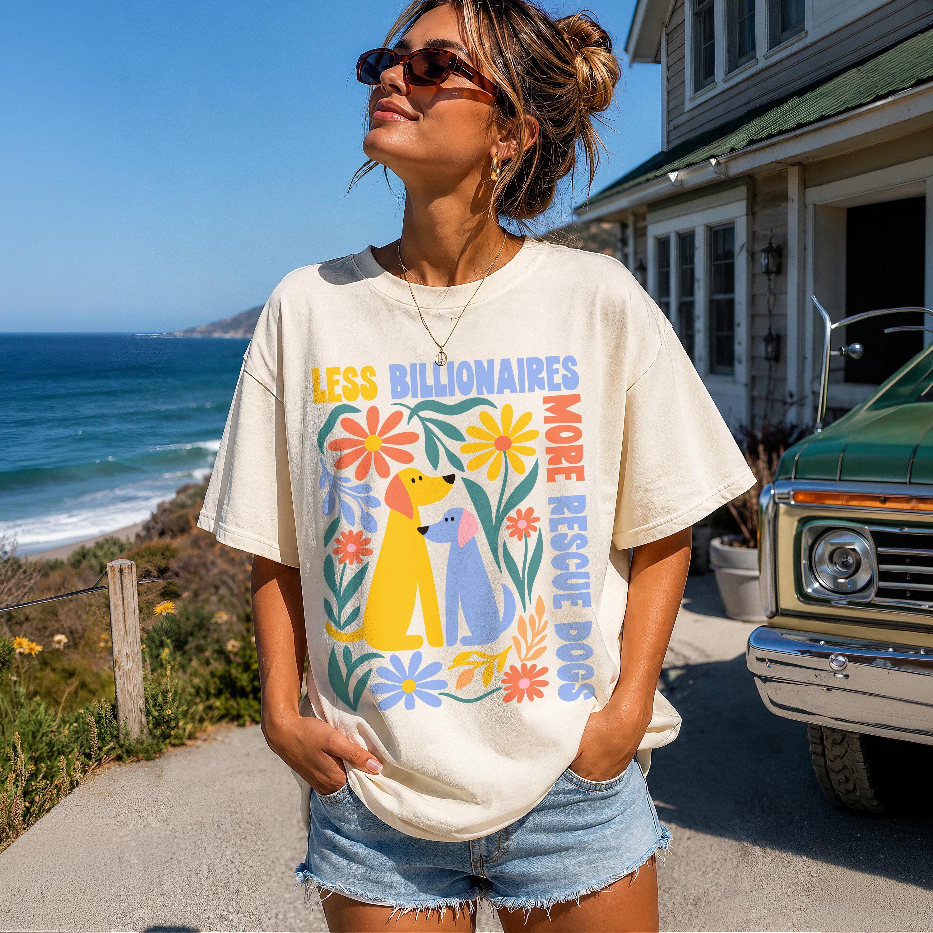 Cream t-shirt with &amp;quot;Less Billionaires, More Rescue Dogs&amp;quot; and floral dog graphic.