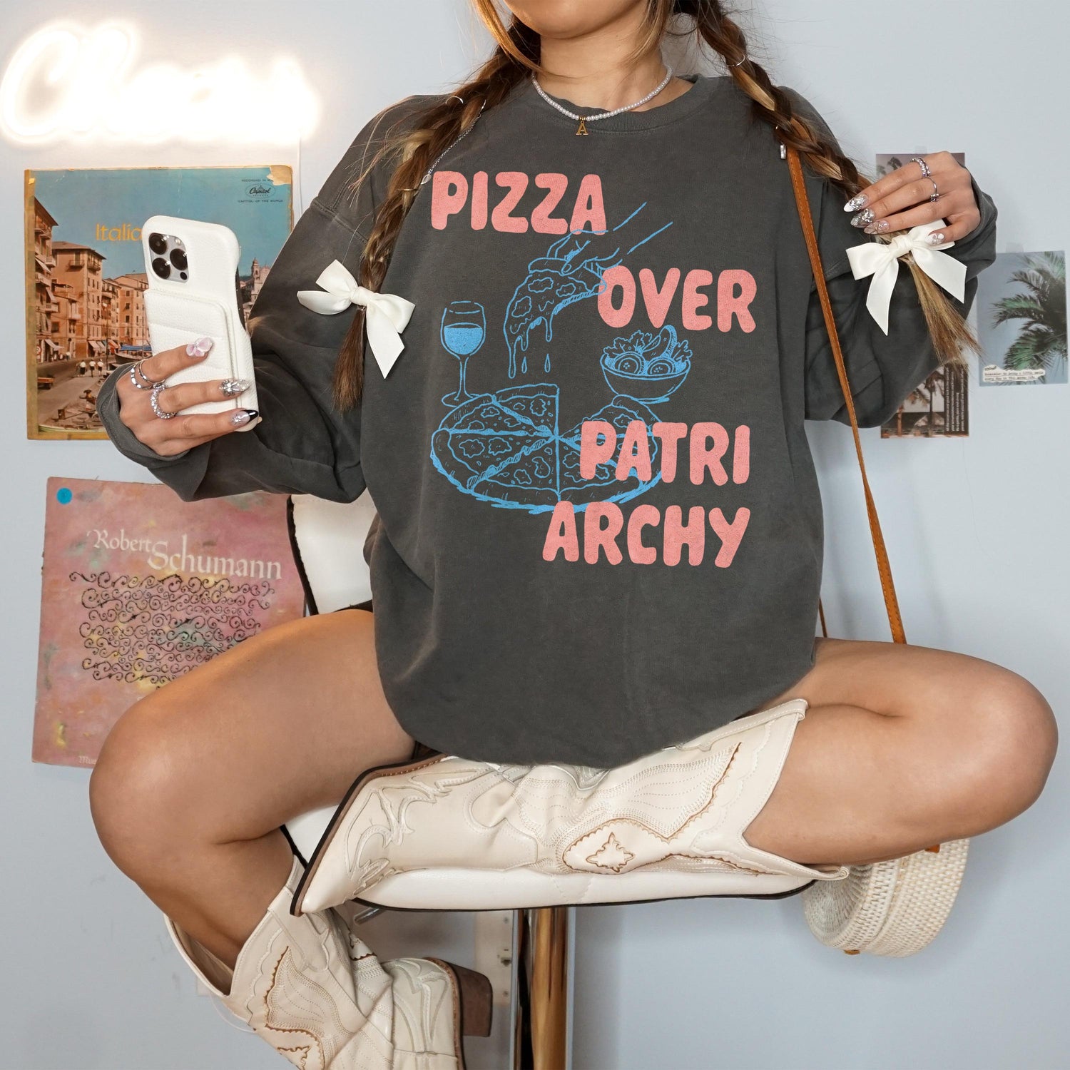 Dark grey sweatshirt with &amp;quot;Pizza Over Patriarchy&amp;quot; graphic, cowboy boots, and accessories.