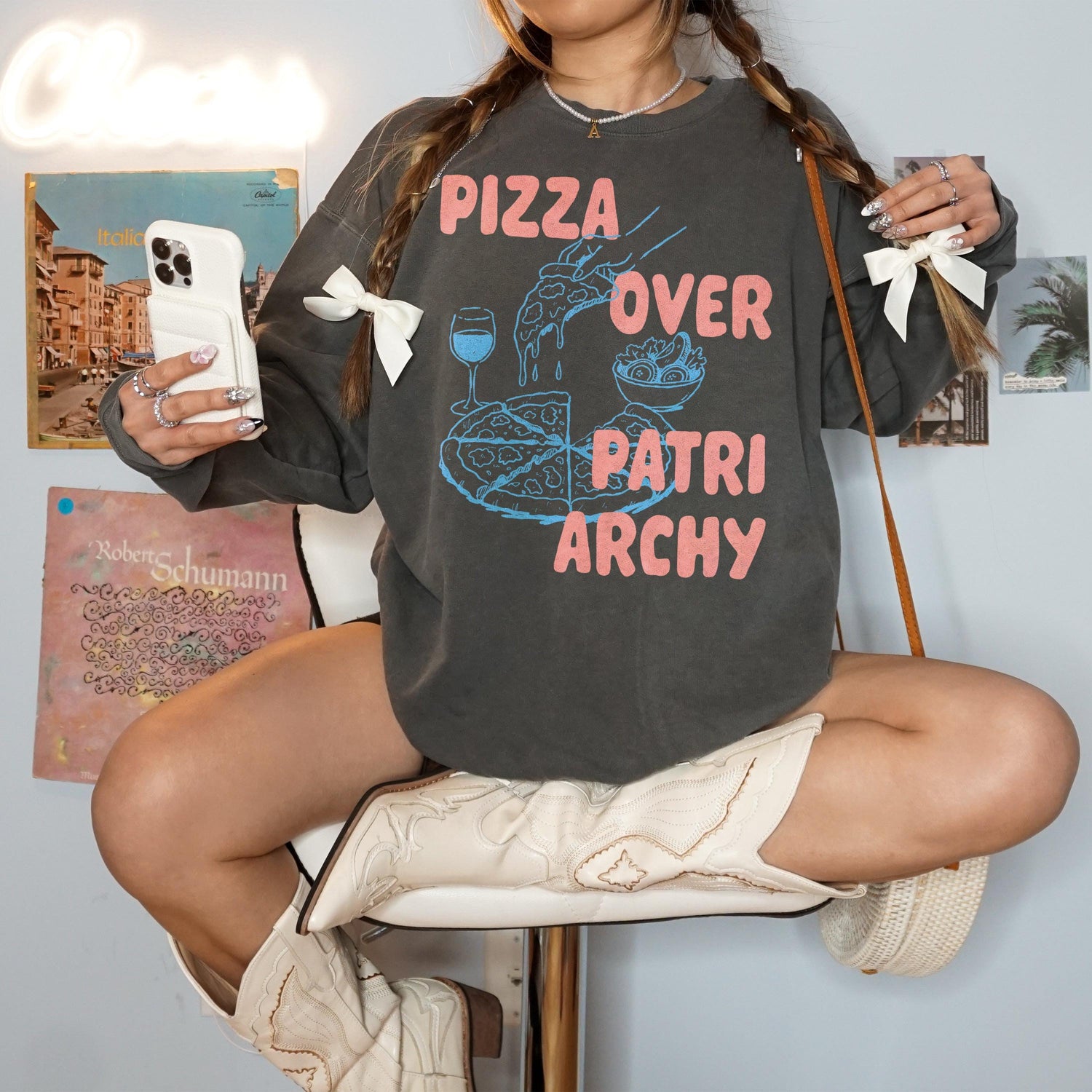 Dark grey sweatshirt with &amp;quot;Pizza Over Patriarchy&amp;quot; graphic, cowboy boots, and accessories.