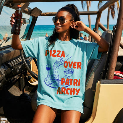 Light blue t-shirt with &amp;quot;Pizza Over Patriarchy&amp;quot; graphic worn by a woman holding a soda.