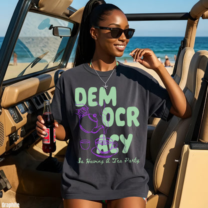 Woman in sunglasses wearing dark t-shirt with &amp;quot;DEMOCRACY IS HAVING A TEA PARTY&amp;quot; graphic.