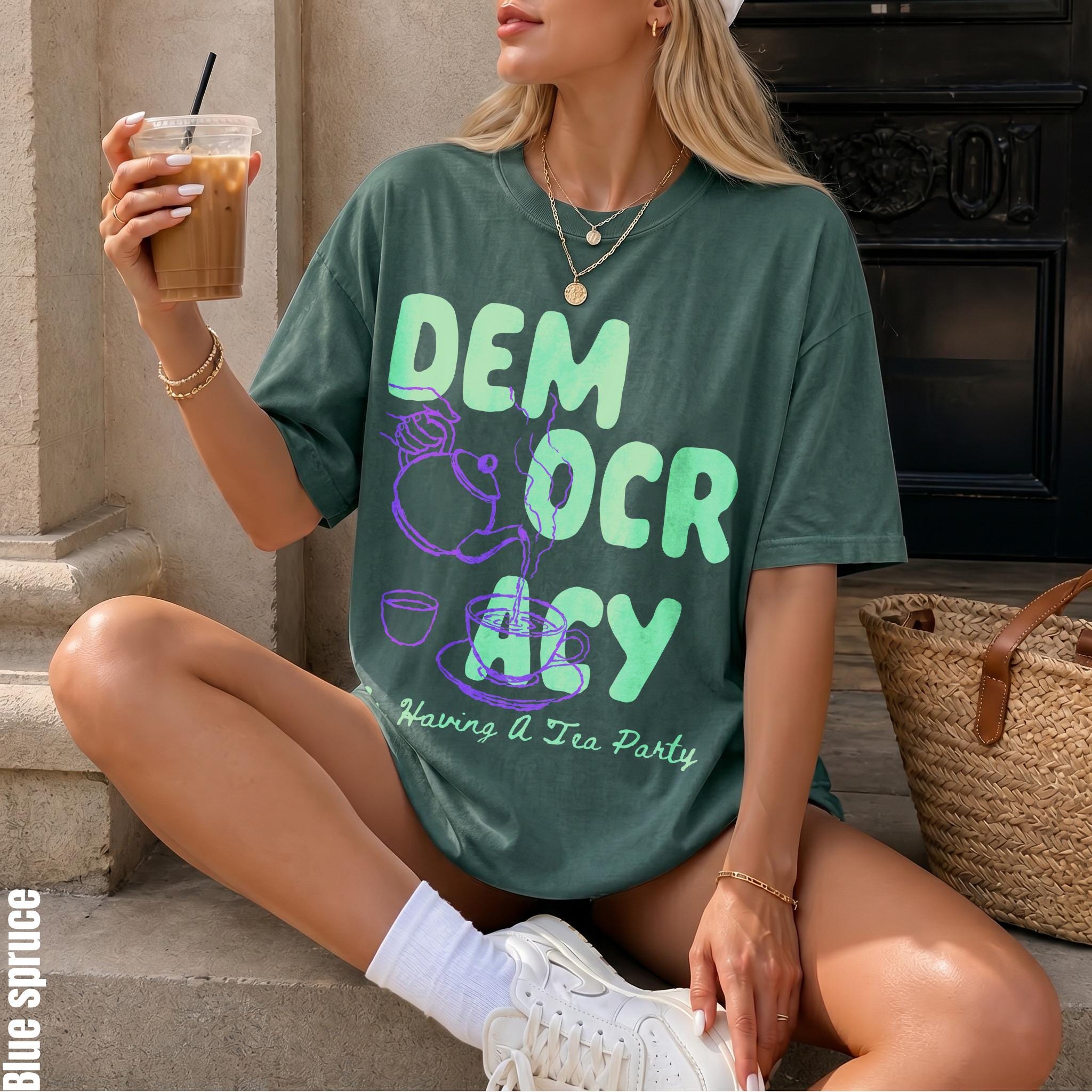 Green t-shirt with &amp;quot;Democracy Having a Tea Party&amp;quot; graphic, woman holding iced drink.