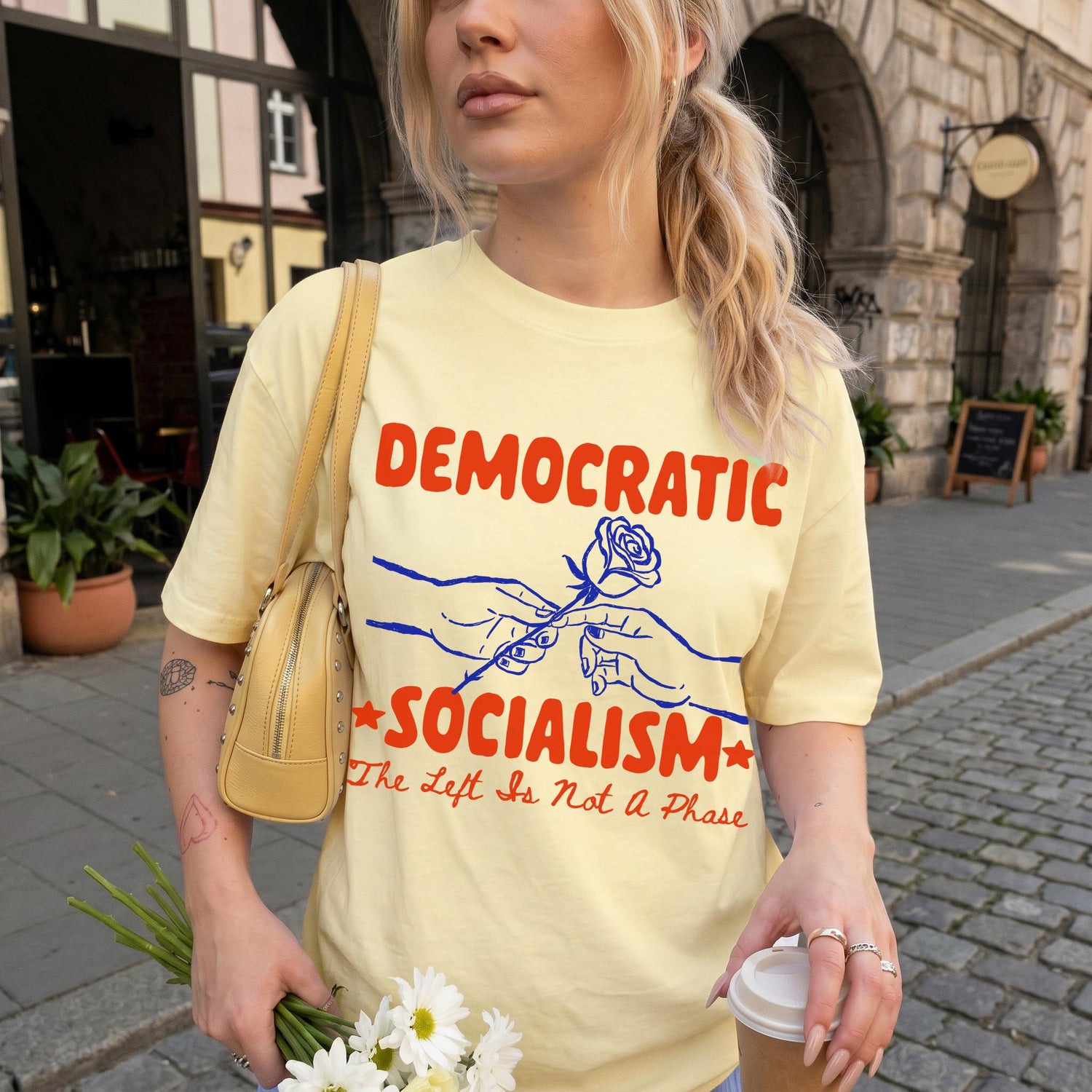 Yellow t-shirt with &amp;quot;DEMOCRATIC SOCIALISM&amp;quot; and &amp;quot;The Left Is Not a Phase&amp;quot; text.