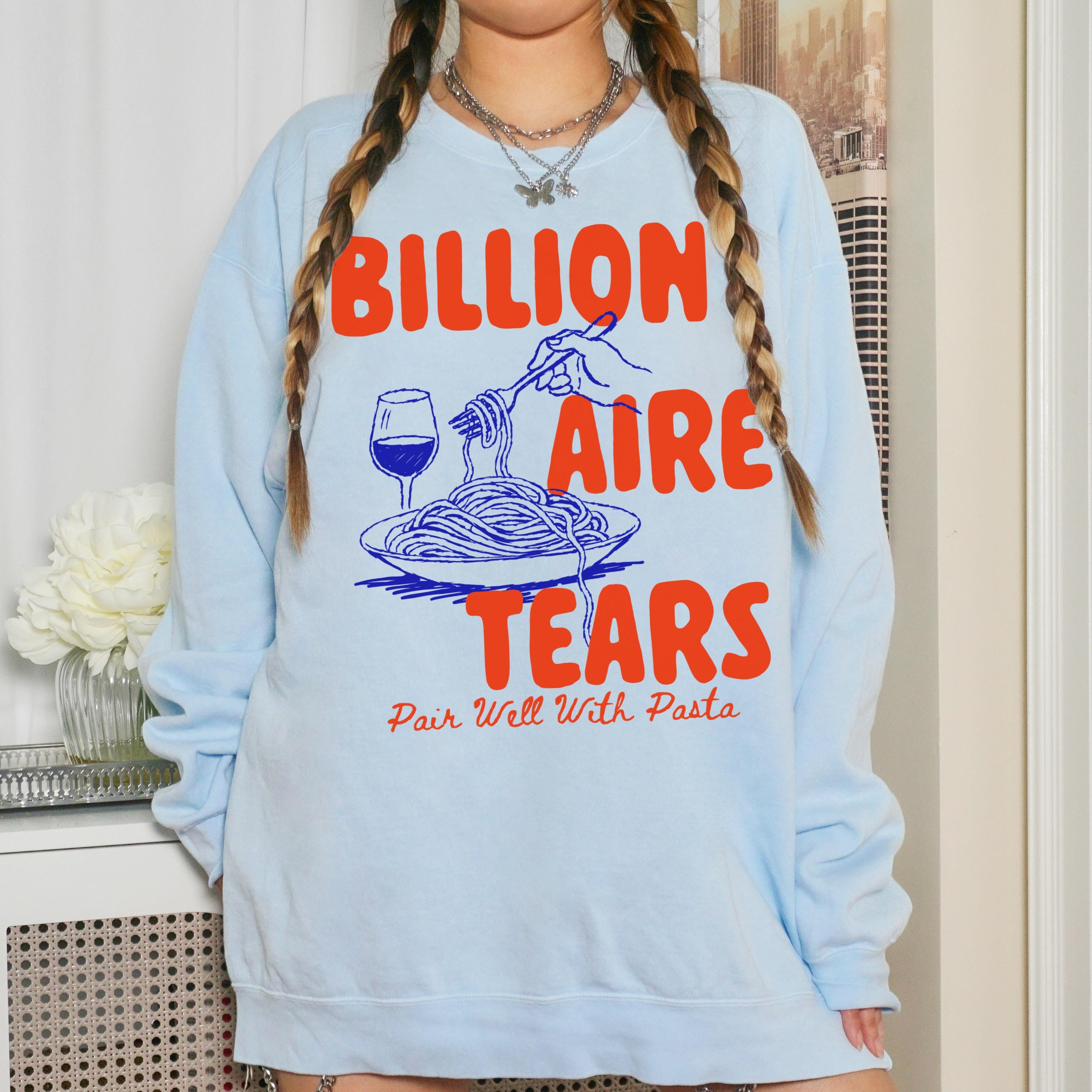 Light blue sweatshirt with orange text: Billionaire Tears. Pair Well With Pasta.