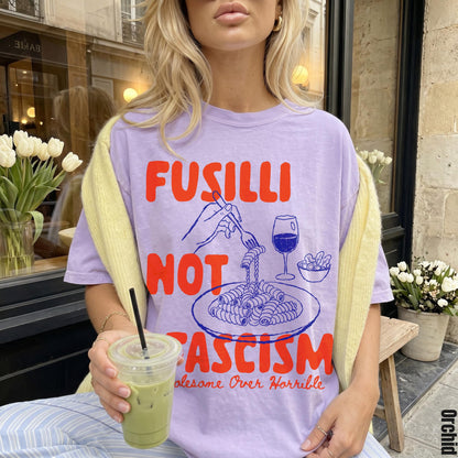 Purple t-shirt with red Fusilli Not Fascism text and pasta illustration.