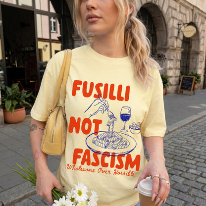 Yellow t-shirt with &amp;quot;FUSILLI NOT FASCISM Wholesome Over Horrible&amp;quot; text and pasta graphic.