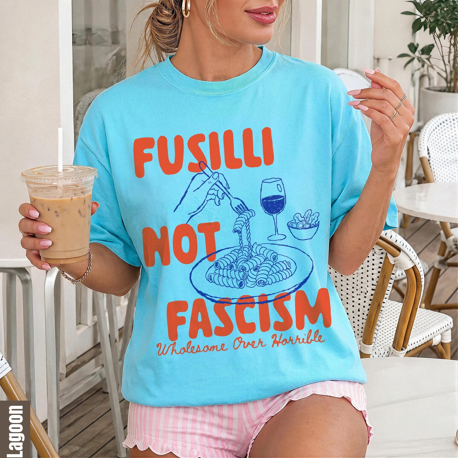 Blue t-shirt with orange text &amp;quot;Fusilli Not Fascism Wholesome Over Horrible&amp;quot; and pasta graphic.