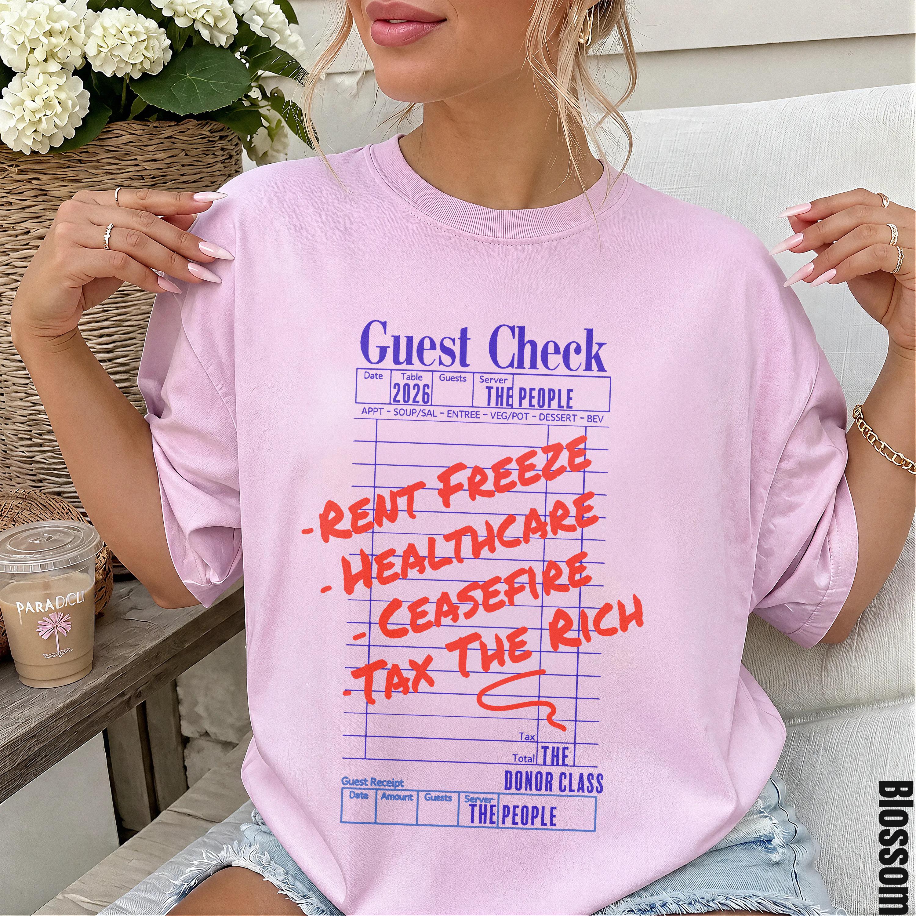 Guest check tee with red text listing demands: rent freeze, healthcare, cease fire, tax the rich.