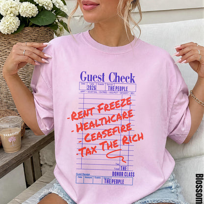 Guest check tee with red text listing demands: rent freeze, healthcare, cease fire, tax the rich.