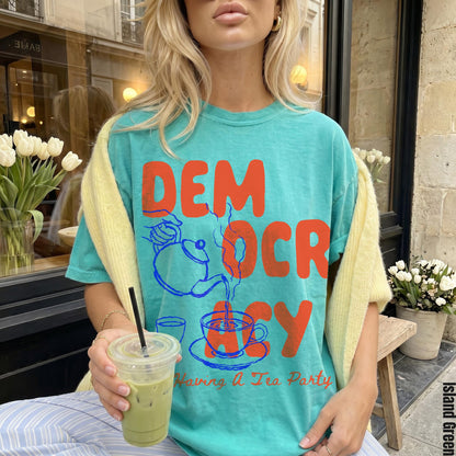 Teal t-shirt with orange DEMOCRACY graphic and &amp;quot;Having A Tea Party&amp;quot; text.