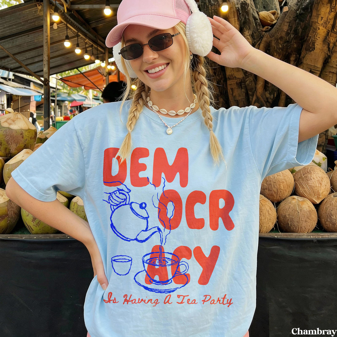 Light blue t-shirt with red text &amp;quot;DEM OCR CY&amp;quot; and illustration, &amp;quot;Is Having A Tea Party&amp;quot;.