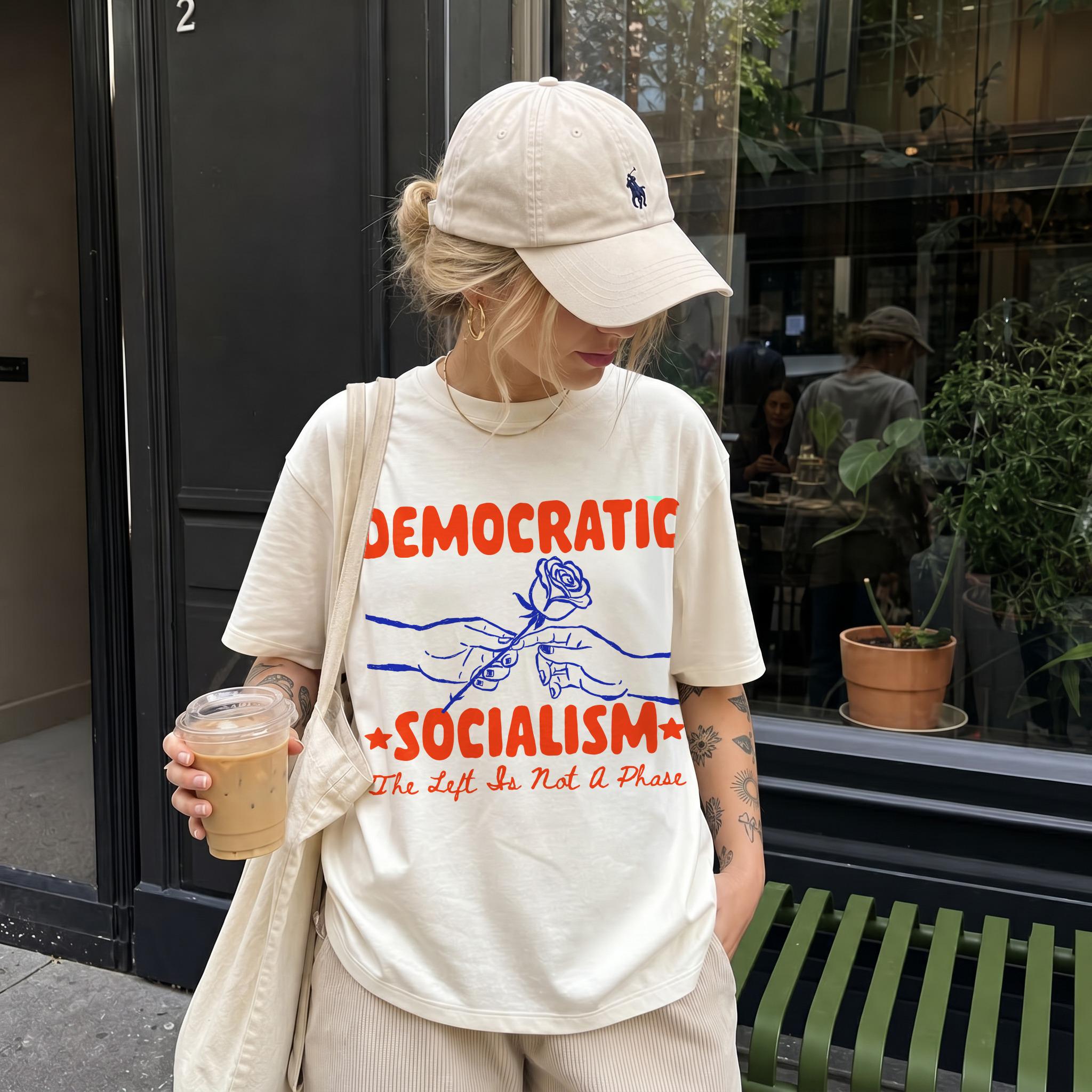 Cream t-shirt with red &amp;quot;DEMOCRATIC SOCIALISM&amp;quot; text, a rose, and &amp;quot;The Left Is Not A Phase&amp;quot;.