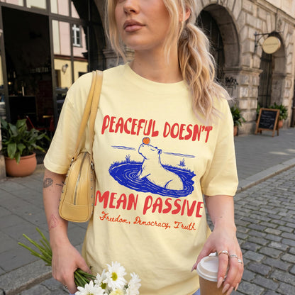 Yellow t-shirt with text: Peaceful Doesn&amp;