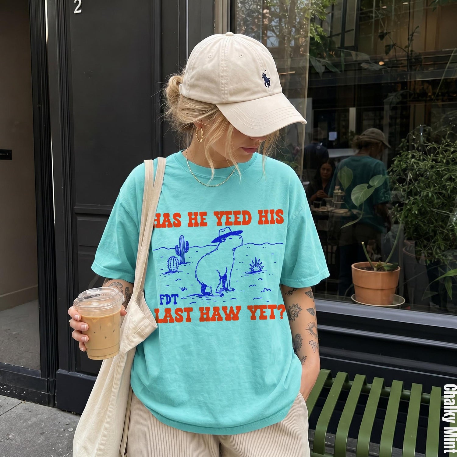 Aqua t-shirt with &amp;quot;HAS HE YEED HIS LAST HAW YET?&amp;quot; and capybara graphic.
