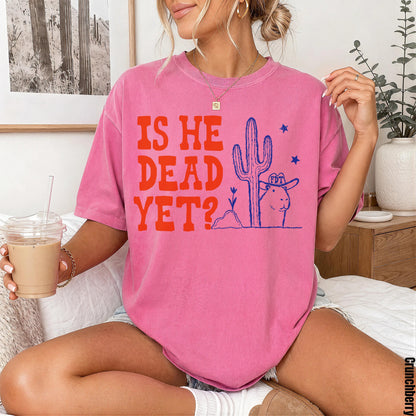 Pink t-shirt with &amp;quot;IS HE DEAD YET?&amp;quot; graphic featuring a cowboy hat-wearing prairie dog and cactus.