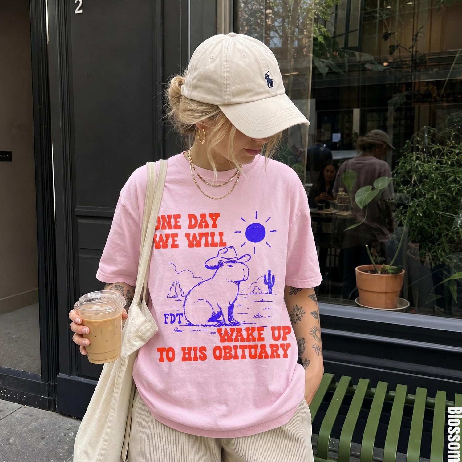 Pink t-shirt with text &amp;quot;ONE DAY WE WILL WAKE UP TO HIS OBITUARY&amp;quot; and capybara graphic.
