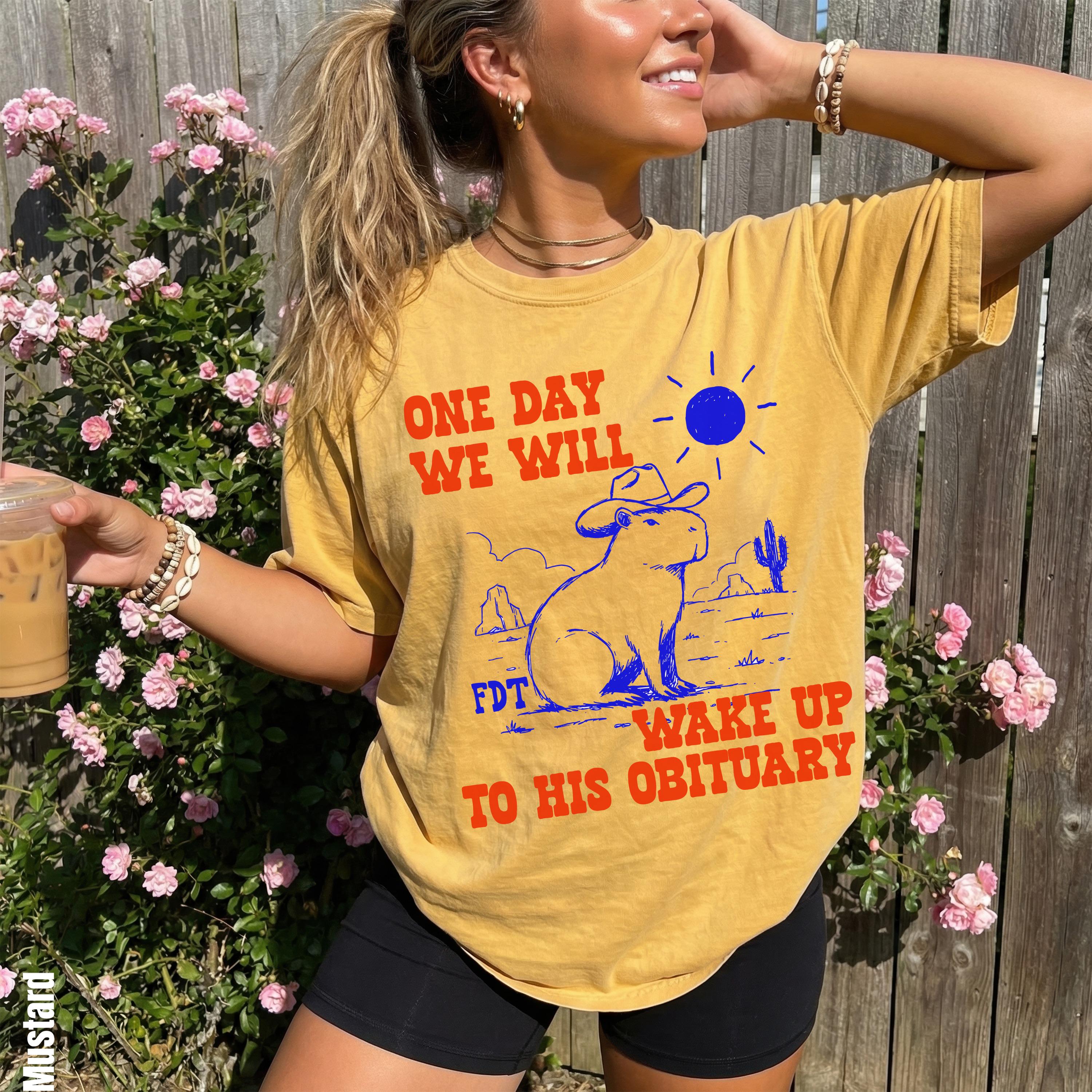 Yellow t-shirt with &amp;quot;ONE DAY WE WILL FDT WAKE UP TO HIS OBITUARY&amp;quot; text and capybara graphic.