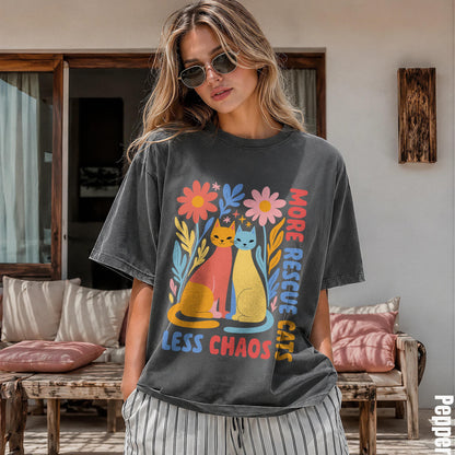 T-shirt with graphic of two cats and floral design, text &amp;quot;MORE RESCUE LESS CHAOS&amp;quot;.