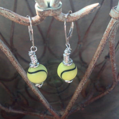 Fun Novelty Sports Earrings shaped like a tennis ball, great for wearing at tennis tournaments, designed by Enlivenadorn by Gwynstone.