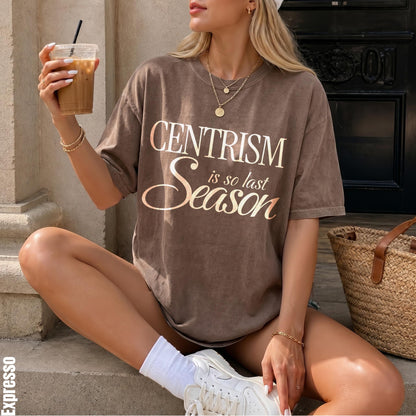 Brown t-shirt with &amp;quot;CENTRISM is so last Season&amp;quot; graphic, held iced coffee, straw bag.