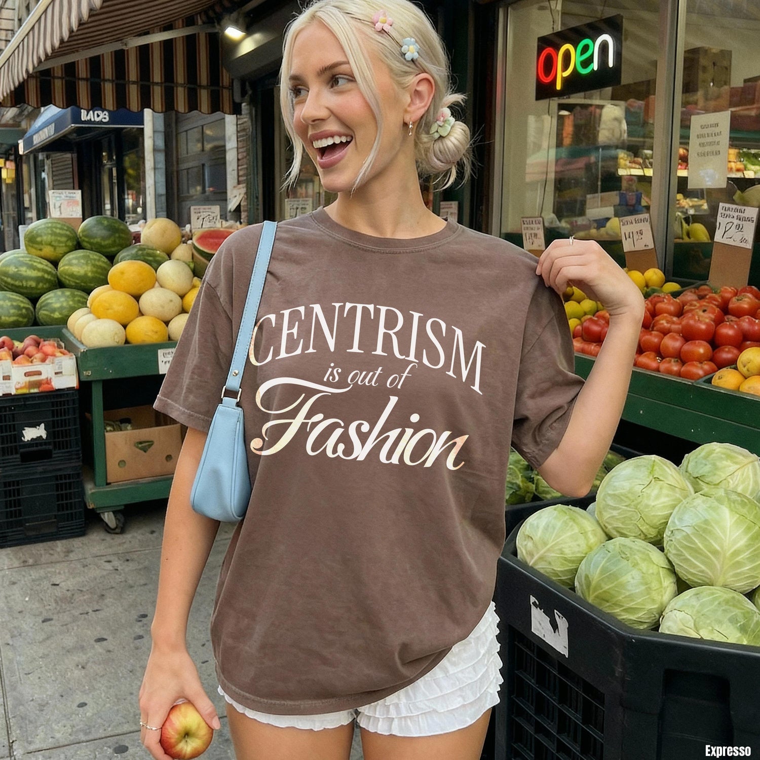 Brown t-shirt with white text reading &amp;quot;CENTERISM is out of Fashion&amp;quot; worn by a smiling woman.