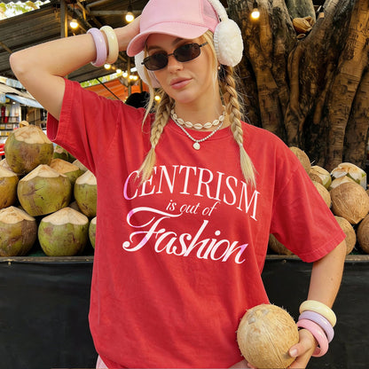 Woman in red t-shirt with &amp;quot;Centrism is out of Fashion&amp;quot; text, holding a coconut.