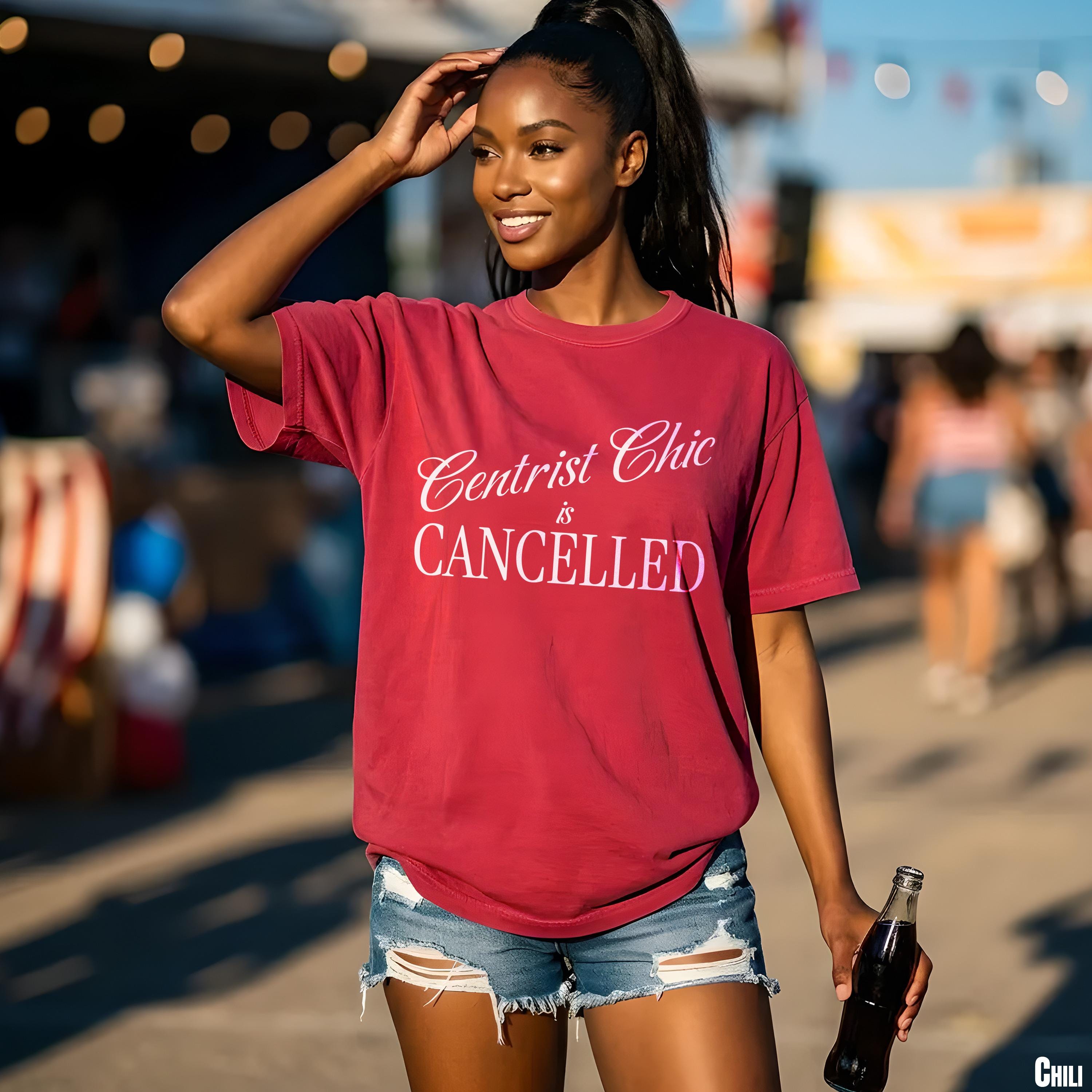 Maroon t-shirt with white text &amp;quot;Centrist Chic is CANCELLED&amp;quot; held by a woman with a bottle.