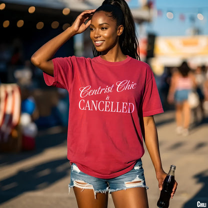 Maroon t-shirt with white text &amp;quot;Centrist Chic is CANCELLED&amp;quot; held by a woman with a bottle.