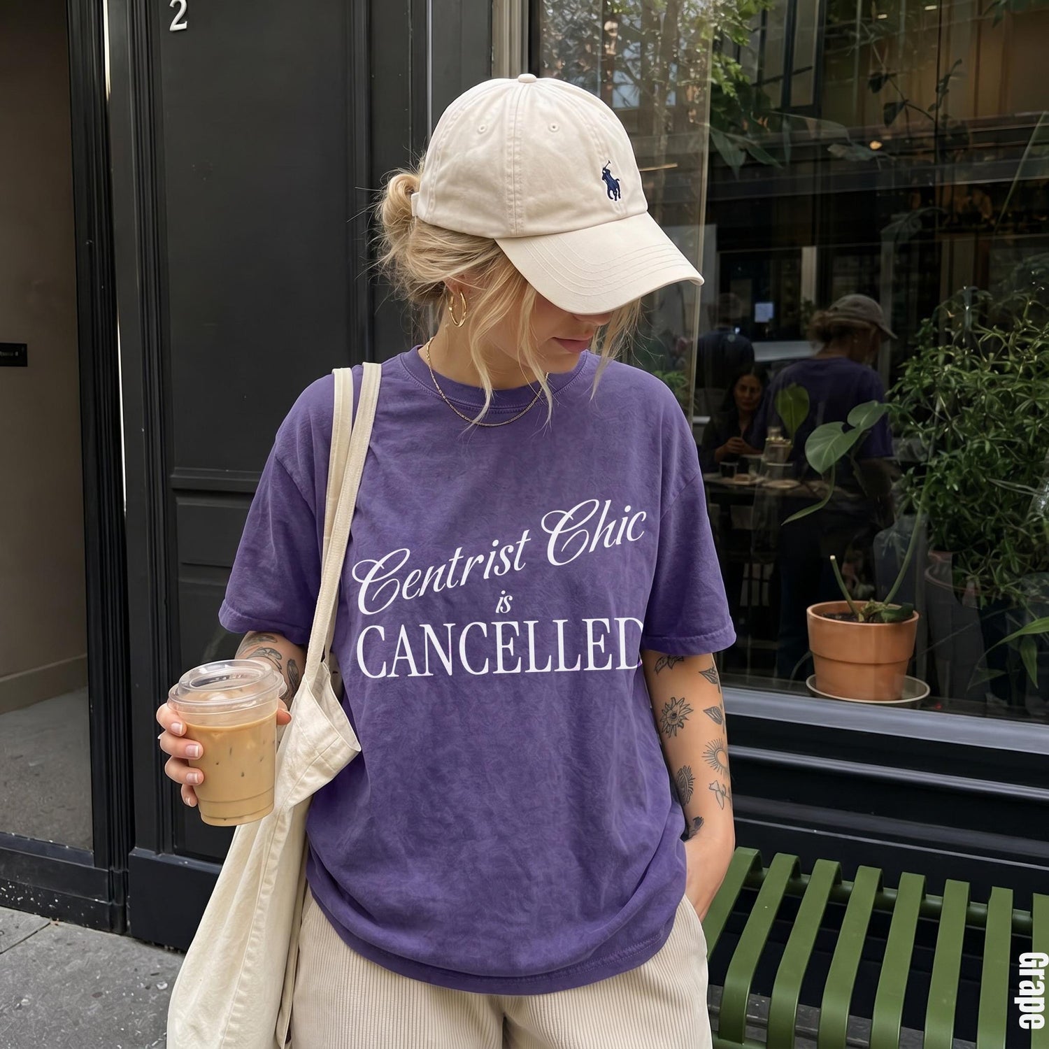 Purple t-shirt with &amp;quot;Centrist Chic is Cancelled&amp;quot; text, worn by person with baseball cap.