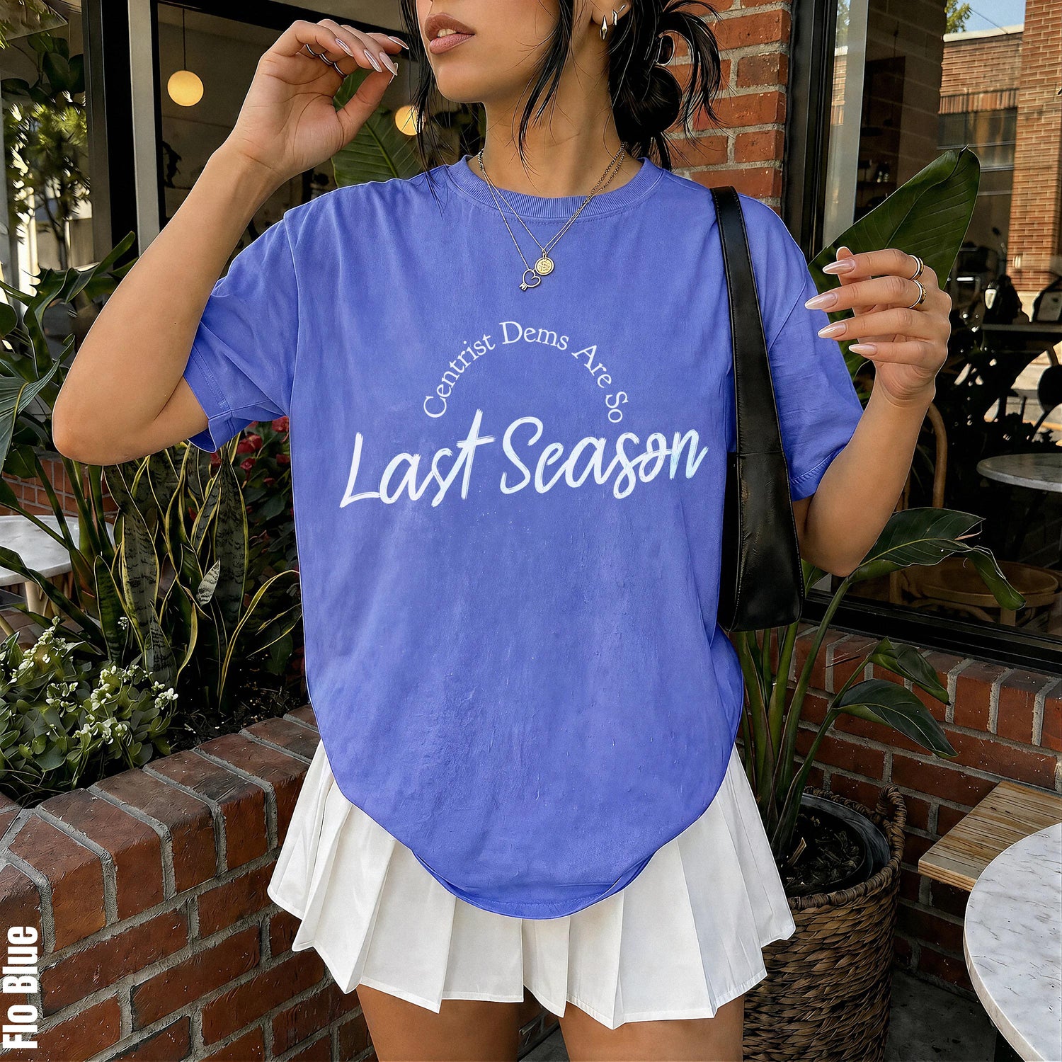Blue t-shirt with &amp;quot;Centrist Dems Are So Last Season&amp;quot; text and a white pleated skirt.